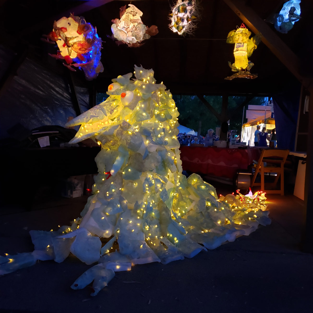 Margaret Craig's Creature from the Bleached Lagoon under Alternative Evolutions lanterns at the Smoky Hill River Festival, Salinas, KS.