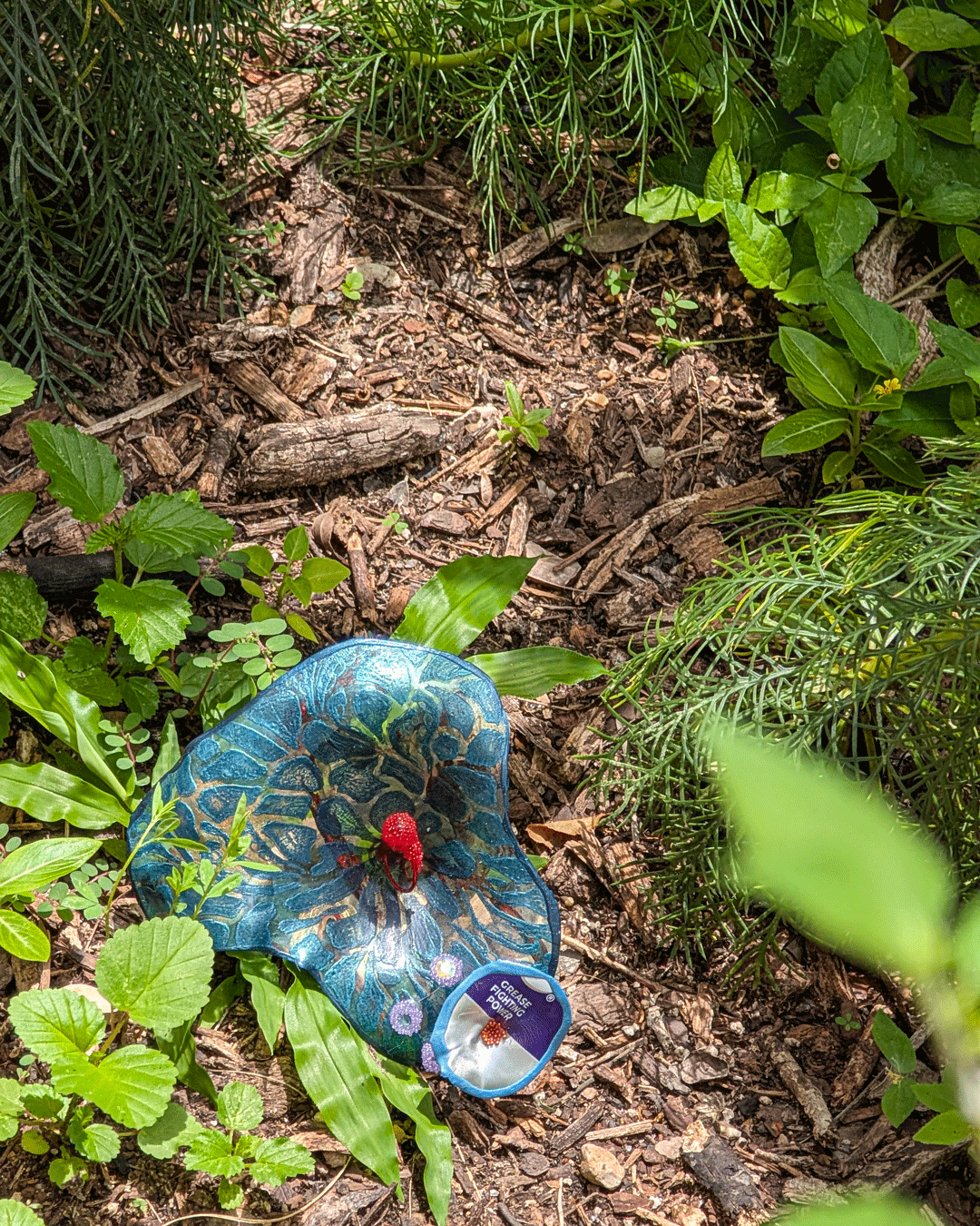 One of Margaret Craig's Setting Seed sculptures rests among the plants on Blackburn Patio at the McNay Art Museum.